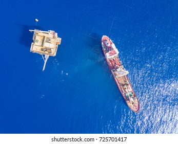 Soil Boring Boat (a geotechnical drilling cum analogue survey vessel) close to a oil platform - Shutterstock ID 725701417