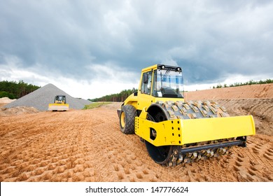 Soil compactor and bulldozer during road construction works - Powered by Shutterstock