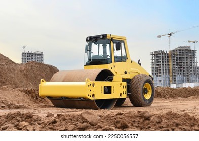 Soil Compactor for leveling ground for foundation and on road construction. Road compaction equipment at construction site. Vibration single-cylinder road roller on sunset. Building construction. - Powered by Shutterstock