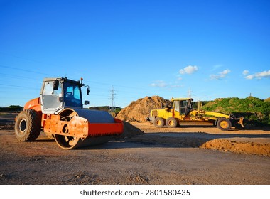 Soil Compactor on compact the road surface. Motor Grader on road construction.  Heavy machinery for grading and road compaction equipment at construction site. Greyder and vibration single-cylinder road roller, Vibratory Soil Compactor. Single Drum Roller on highway construction.