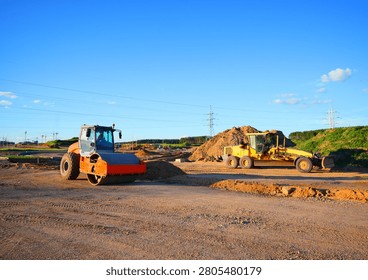 Soil Compactor on compact the road surface. Motor Grader on road construction.  Heavy machinery for grading and road compaction equipment at construction site. Greyder and vibration single-cylinder road roller, Vibratory Soil Compactor. Single Drum Roller on highway construction.