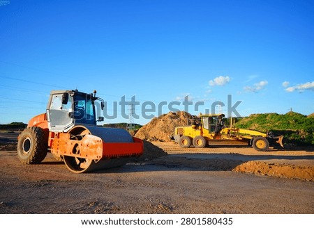 Soil Compactor on compact the road surface. Motor Grader on road construction.  Heavy machinery for grading and road compaction equipment at construction site. Greyder and vibration single-cylinder road roller, Vibratory Soil Compactor. Single Drum Roller on highway construction.