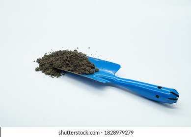 Soil On Small Shovel Isolated On White Background.