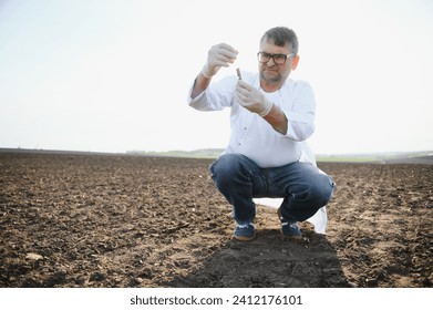 Soil Sampling. Agronomist taking sample with soil probe sampler. Environmental protection, organic soil certification, research.