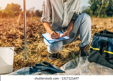 Soil Test. Female Agronomist Taking Notes In The Field. Environmental Protection, Organic Soil Certification, Research