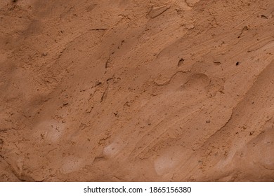 Soil wall texture of clay house structure. Mud background. selective focus