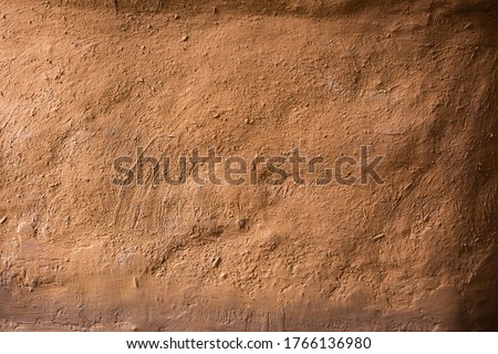 Soil wall texture of old clay house structure. Mud background. Soft picture,vintage tone