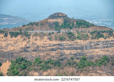 The Solapur to Mumbai Vande Bharat Express travels down hill on the Bhor Ghats at Monkey Hill near Khandala. - Shutterstock ID 2276747507