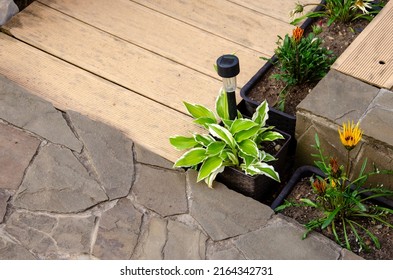 Solar Battery. Lamp. Garden. Path Lighting. Saving Energy At Home. Alternative Energy Sources In Everyday Life. Garden Path And Flower Bed