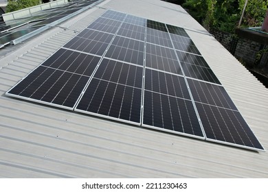 Solar cell arrays are arranged in a square arrangement on a metal sheet roof. It has a side view and was created using n-type technology.