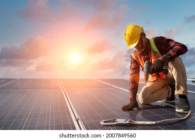 Solar cell A man working at solar power station Installing a Solar Cell on a Roof. - Shutterstock ID 2007849560