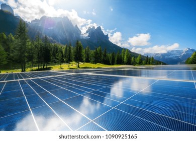 Solar Cell Panel In Country Landscape Against Sunny Sky And Mountain Backgrounds. Solar Power Is The Innovation For Sustainability Of World Energy. Sustainable Resources.