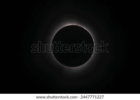 Solar Eclipse,  April 8, 2024,  Copenhagen Ontario Canada.  Solar flares are visible as totality is achieved.  Moon, sun, glow, fire, dark, total, 