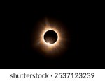 Solar eclipse closeup with sun peeking through 