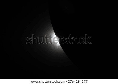 Solar Eclipse Emergence: Captured from Orion near the end of Artemis II's lunar flyby on April 6, the Sun begins to peek from behind the Moon, casting light along the lunar limb and revealing normally hidden topography.
