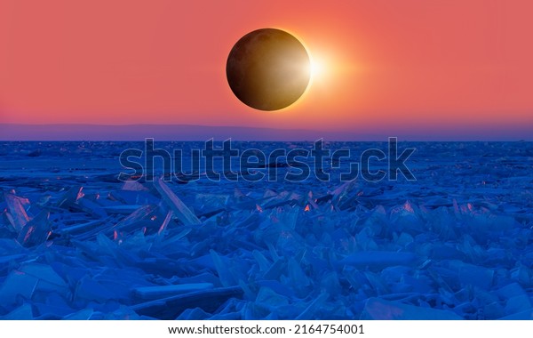 Solar eclipse over the Baikal lake - Beautiful\
winter landscape of frozen Lake Baikal at sunrise - \