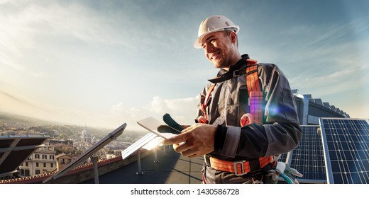 Solar Energy Engineer Using Tablet For Check Power Station In Roof