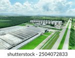 Solar energy for factory and warehouse building. Solar panels on roof of industrial plant. Commercial solar power. Rooftop solar power. Rooftop renewable energy system. Sustainable green energy.