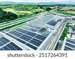 Solar energy for factory and warehouse building. Solar panels on roof of industrial plant. Commercial solar power. Rooftop solar power. Rooftop renewable energy system. Sustainable green energy.