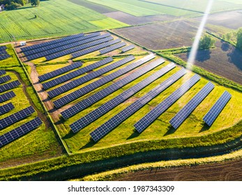 Solar Energy Farm In Fields. Aerial Drone View.