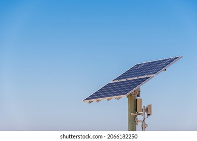 Solar energy panel photovoltaic cell on the pole on the blue sky. Renewable energy. Enviroinment conservation and energy saving. Solar powered equipment