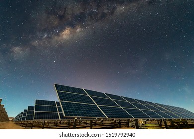 Solar Energy Panels view, a nice technology blue pattern at Atacama Desert arid lands. The solar modules going to the infinity with the Milky Way trying to get energy from the stars on the night sky 