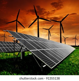 Solar Energy Panels And Wind Turbine In The Setting Sun