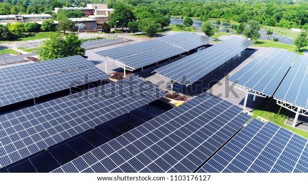 solar energy power in car station,\
Aerial drone view of solar panel covered parking\
roof
