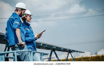 Solar engineers visually examine panel arrays on farm sites using blueprints and drawings to ensure that the alignment, surface, sunlight access, and structural stability meet standard requirements.
