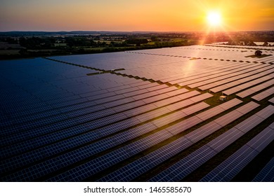 Solar Farm At Sunrise On A Summers Day