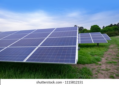 Solar Farm In UK, Photovoltaic Panels In Green Field. Solar Energy Is Part Of The Net Zero Emissions Target For The UK