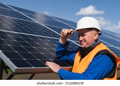Solar Farm Worker Leaning Against The Panels