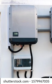 Solar Inverter On The Side Of A House	