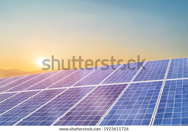 Solar\
panel against sunset background. Photovoltaic, alternative\
electricity source. Idea for sustainable\
resources