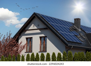 Solar panel array on the roof of a contemporary house - Shutterstock ID 2296024243