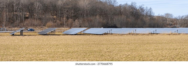 Solar panel array in open field generating renewable energy in rural landscape