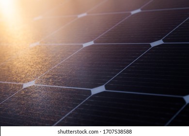 Solar panel close-up with the rays of the setting sun in the corner.