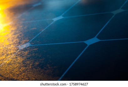 Solar panel close-up with the rays of the setting sun in the corner.