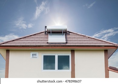 Solar Panel For Hot Water System On Roof On Blue Sky And Sun Background