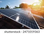 Solar panel installation on clay roof in blue sky with sun background