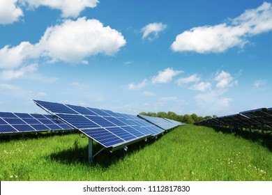 Solar panel on blue sky background. Green grass and cloudy sky. Alternative energy concept - Shutterstock ID 1112817830