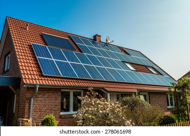 Solar panel on a red roof  - Shutterstock ID 278061698