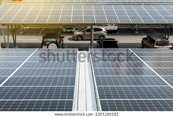 Solar Panel Photovoltaic installation on a Roof\
of car parking lot, alternative electricity source - Sustainable\
Resources Concept.