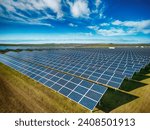 Solar panel produces green, environmentaly friendly energy from the setting sun. Aerial view from drone. Landscape picture of a solar plant that is located inside a valley
