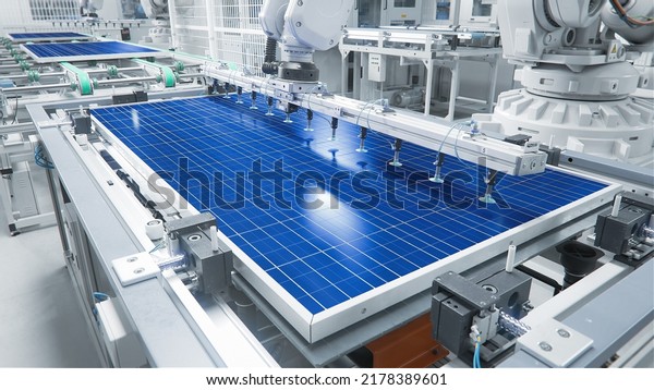 Solar Panel Production Process at Modern\
Bright Automated Factory. Robot Arm on Assembly Line is Moving\
Solar Panel During\
Manufacturing.