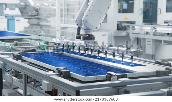 Solar Panel\
Production Process at Modern Bright Automated Factory. Robot Arm on\
Assembly Line is Placing Solar\
Cells.