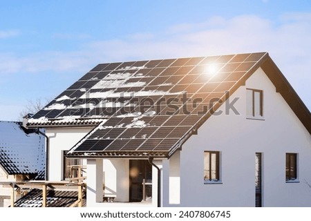 Solar Panel Roof House in Winter. Solar Panels Covered Snow on Roof of Private House. Efficiency Solar Batteries in Winter.