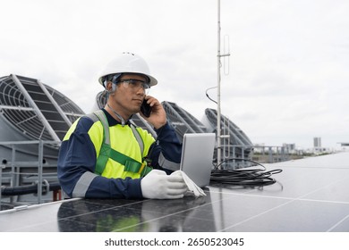 Solar panel rooftop, Rooftop solar power. Engineer using laptop computer inspecting installation and control quality of solar panel on rooftop of building