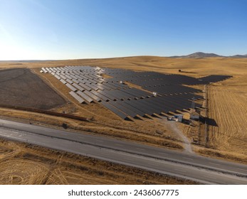 Solar panel rows aerial view. Photovoltaic panels farm from sky, diagonal rows for renewable solar energy. Reducing carbon footprint concept, clean green energy for future.