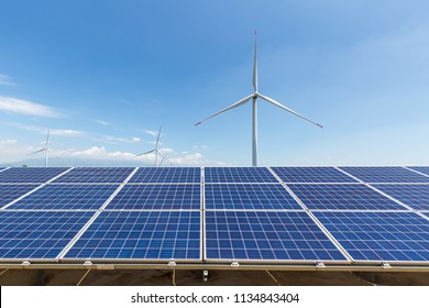 solar panel and wind turbine against a blue sky - Shutterstock ID 1134843404